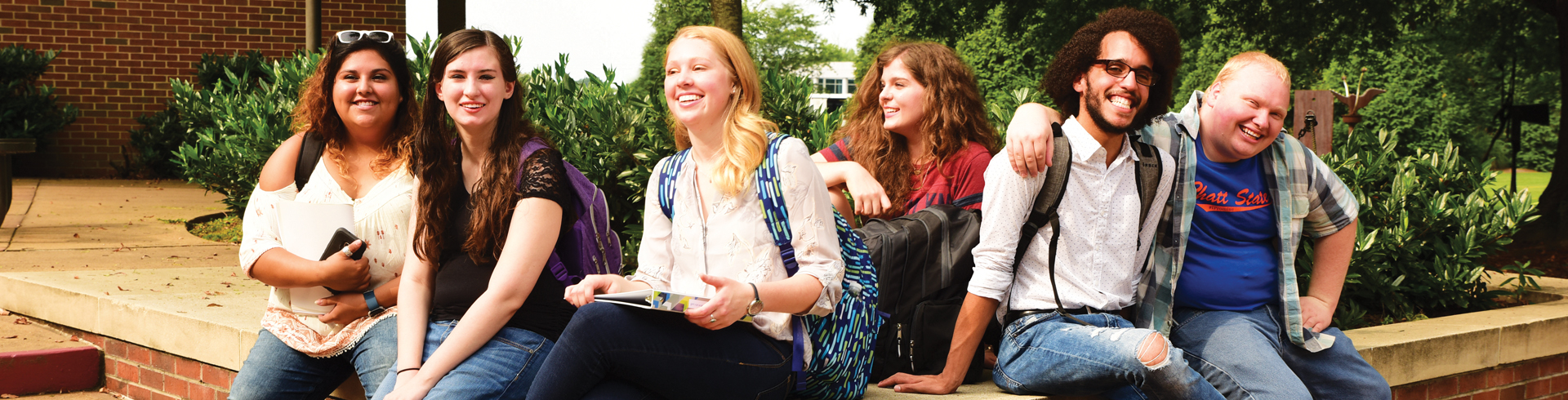 Photo of students sitting in courtyard