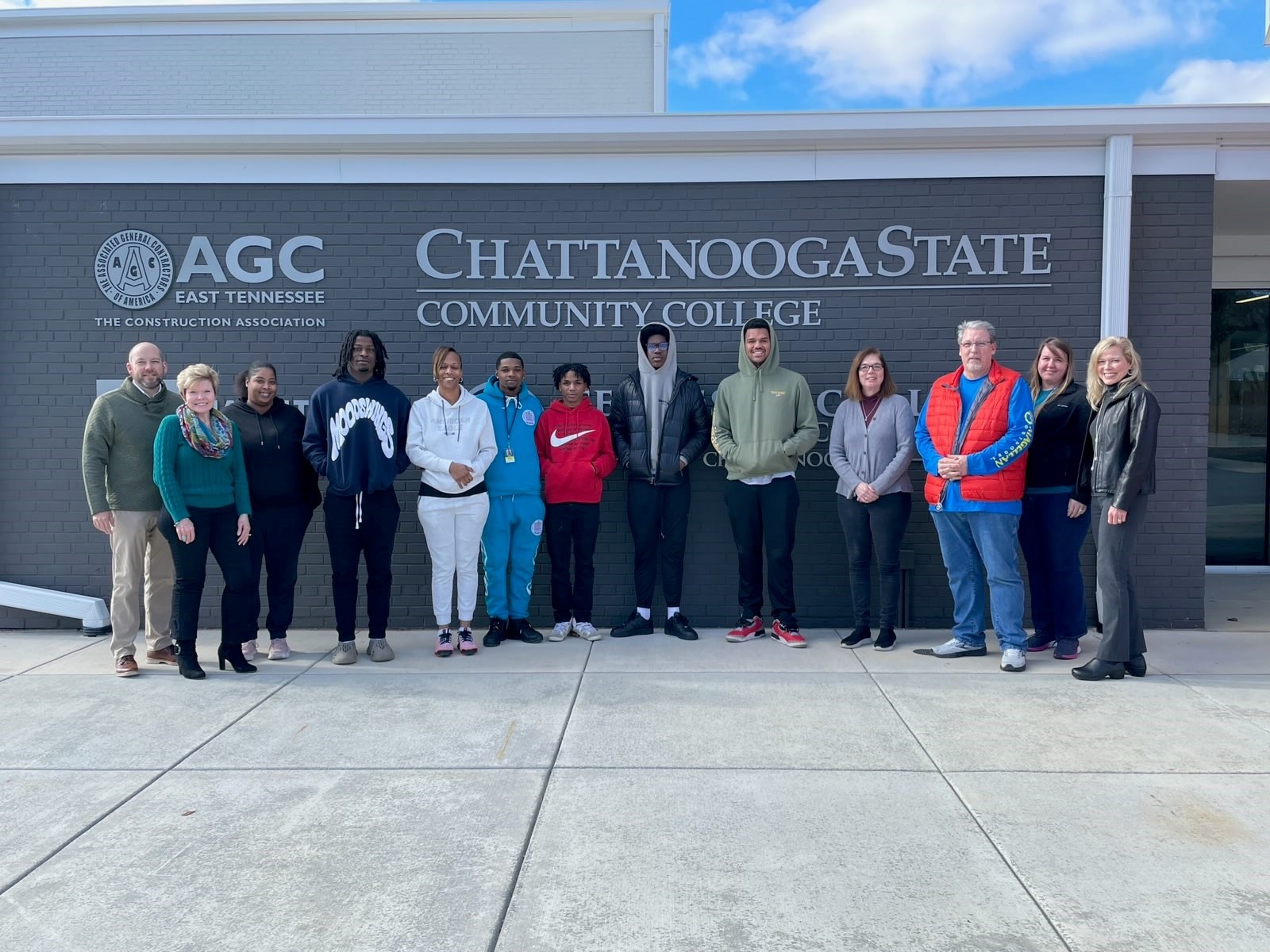 Flooring installation students stand outside ChattState's Construction Career Center.