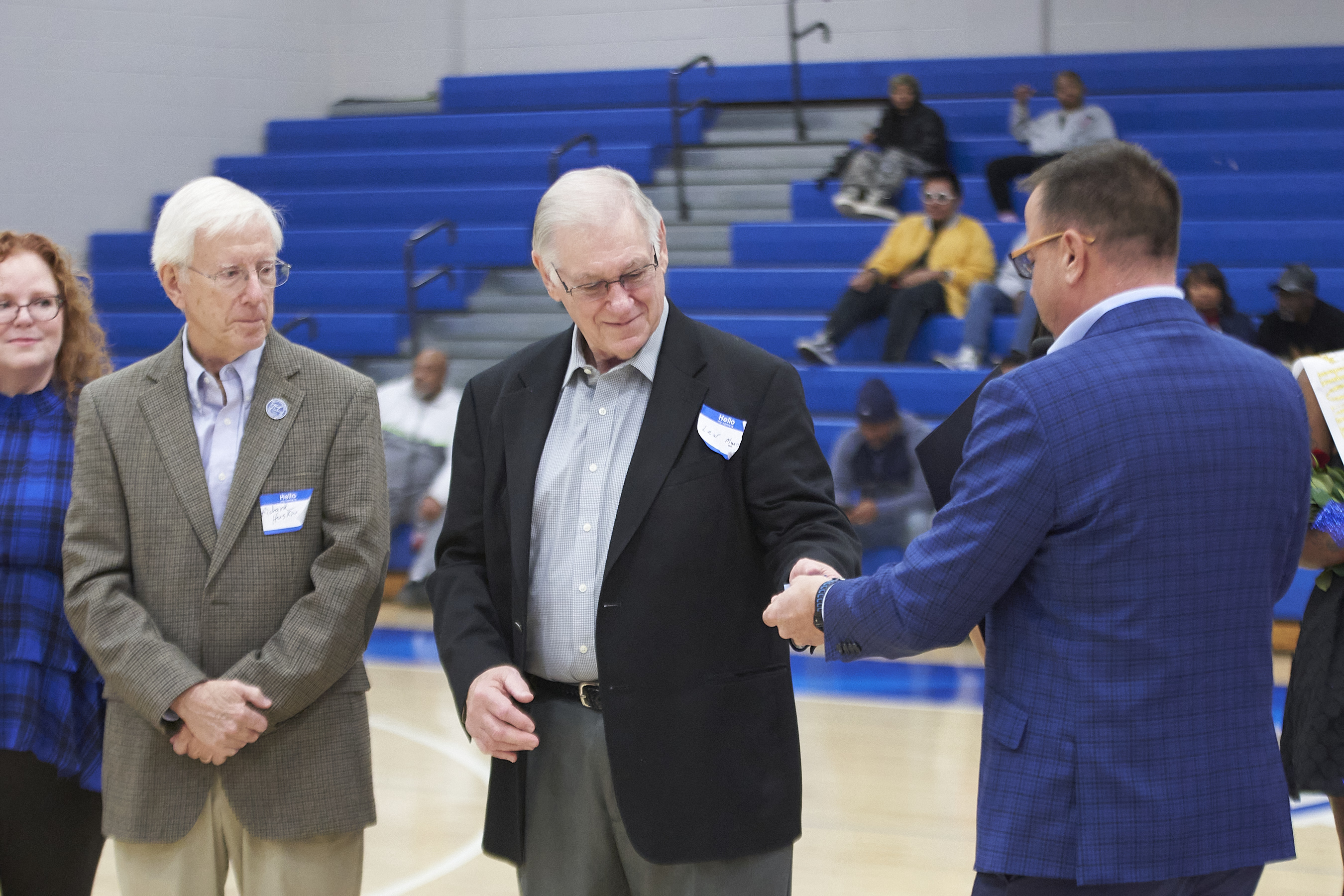 Dennis Tumlin hands Lew Myers a Chattanooga State Alumni Half Century Club lapel pin.