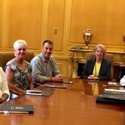 new Chattanooga State Alumni Board members seated left to right at board room table: Dr. Jared Bigham, Morgan Smith, Sherri Shackleford, Dennis Tumlin, Dr. Flora Tydings, Jerry Wagner, Tabatha Armour and Gary Ainscough.