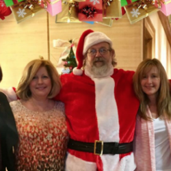 Photo of employees Nancy Patterson, Tammy Sawyers Chef Stan as Santa, Suzanne Harris and Brenda Ingram for a holiday themed image