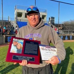 Greg Dennis a holding TCCAA Hall of Fame plaque. 