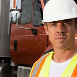 man in front of dump truck