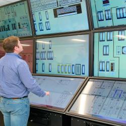 A man looks at a simulated nuclear control room.
