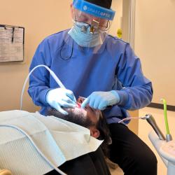 A ChattState dental student cleans a patient's teeth.