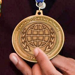 A student holds a ChattState Honors Medallion.