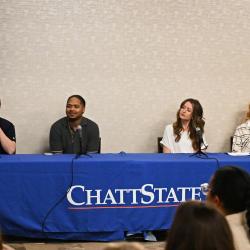 Gary Satin, Jamaal Lundy, Brooke Hale, and Carla Frizzel sit in front of microphones at a table with a ChattState table cloth.