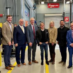 group of people in an auto body shop