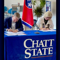 a man and woman signing an agreement