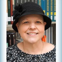 headshot of woman wearing a hat