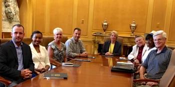 new Chattanooga State Alumni Board members seated left to right at board room table: Dr. Jared Bigham, Morgan Smith, Sherri Shackleford, Dennis Tumlin, Dr. Flora Tydings, Jerry Wagner, Tabatha Armour and Gary Ainscough.