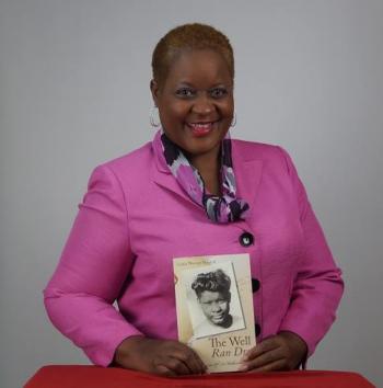 Pictured, Linda Murray Bullard –alum, writer, speaker, entrepreneur--holding her book The Well Ran Dry