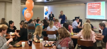 This group photo shows President Ashford speaking to a large group of employees donors during the annual Break of Champions on campus.