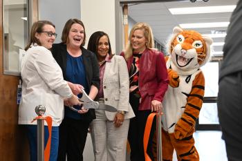 Heather Montgomery, Dr. Amanda Bennett, Dr. Martina Harris, Dr. Rebecca Ashford, and the Ben G. Tiger mascot cut a ribbon with large scissors in front of the Student Health Clinic at ChattState. Heather Montgomery, Dr. Amanda Bennett, Dr. Martina Harris, Dr. Rebecca Ashford, and the Ben G. Tiger mascot cut a ribbon with large scissors in front of the Student Health Clinic at ChattState.