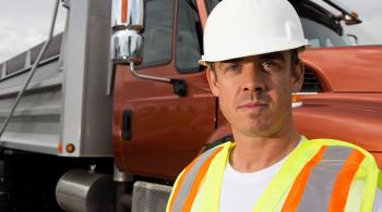 man in front of dump truck