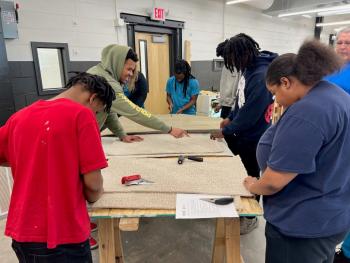 Chattanooga State Community College students practice installing flooring at the ChattState Construction Career Center.