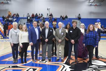 ChattState alumni stand with the ChattState Homecoming Court during Homecoming on Nov. 29, 2023.