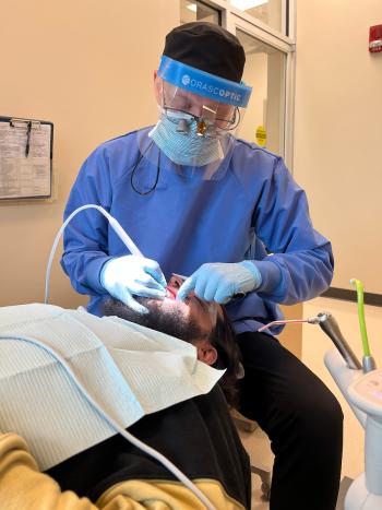 A ChattState dental student cleans a patient's teeth.