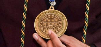 A student holds a ChattState Honors Medallion.