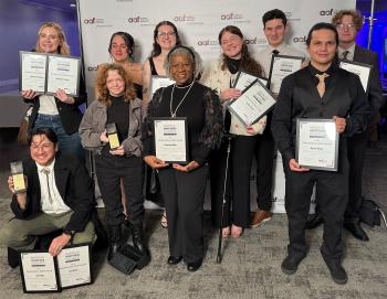 ADDY Awards 2026 10 ChattState students in formal clothing hold ADDY awards in front of an American Advertising Federation backdrop.