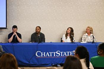 Gary Satin, Jamaal Lundy, Brooke Hale, and Carla Frizzel sit in front of microphones at a table with a ChattState table cloth. Gary Satin, Jamaal Lundy, Brooke Hale, and Carla Frizzel sit in front of microphones at a table with a ChattState table cloth.
