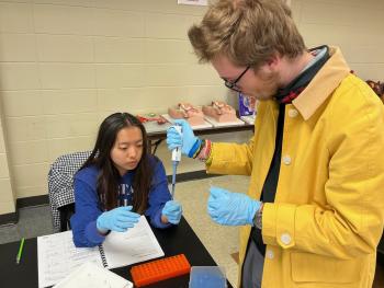 Two students practice extracting DNA in a lab at ChattState.
