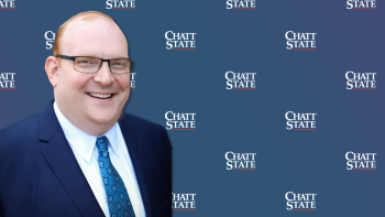 Brad McCormick in front of blue background with ChattState Logo