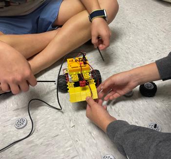 Two people work together to build a RoboThink robot. Two people work together to build a RoboThink robot.