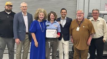 student with award and group of people