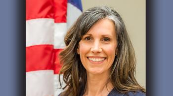 headshot of a woman next to a US flag