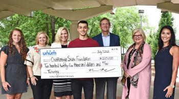 group of people holding a large check for presentation