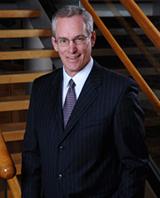 Dr. Jim Barrott poses in front of stairwell of the CBIH building.