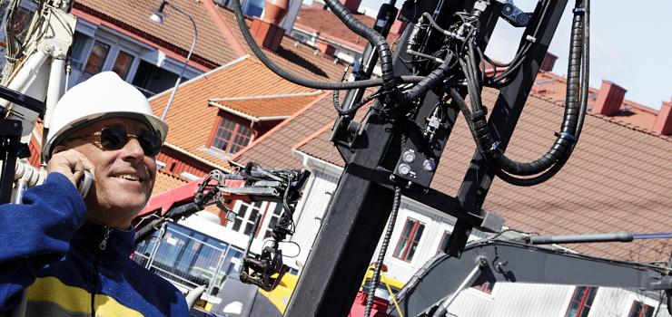 contractor on construction site communicates by mobile device