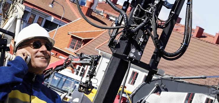 contractor on construction site communicates by mobile device 