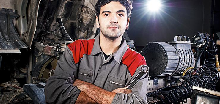 A worker poses in their shop